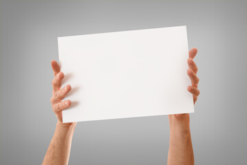 Two hands showing white sheet with stretched fingers isolated background