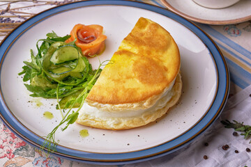 French traditional omelette and green cucumber of Mother Poulard