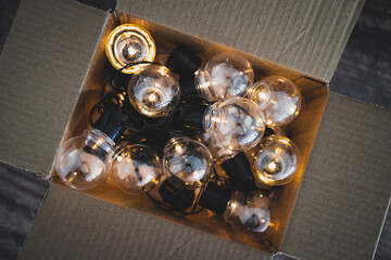 group of light bulbs shining from an open box, mindset and thinking outside the box