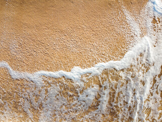 Foam from the sea wave on the sand