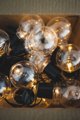 group of light bulbs shining from an open box, mindset and thinking outside the box