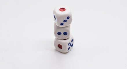 The cube is on the cube. Heap of white cubic dice with blue and red spikes (dots) on a white background. Game, gambling, chance and risk concept