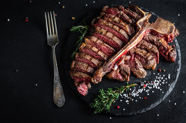 Barbecue Wagyu T-Bone Steak sliced. porterhouse grilled beef steak Medium rare. American meat restaurant served on slate board. banner, catering menu recipe place for text, top view