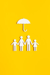 Family figure under umbrella. Insurance and family protection concept