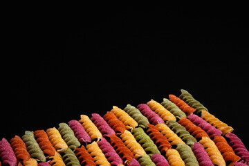 Colourful rice pasta advertisement. Vegan gluten-free diet for health. Macaroni background isolated. 