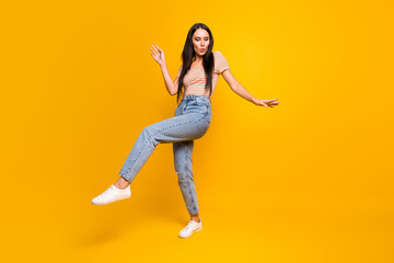 Fototapeta na wymiar Full length body size photo of dancing moving at discotheque girl moving enjoying party isolated on vibrant yellow color background
