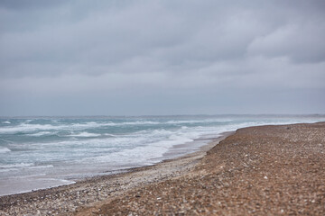 the beach during winter with strong waves