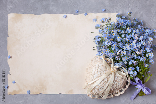 Bouquet of forget me nots flowers and congratulatory paper, letters, heart