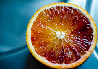A half blood orange on a blue background