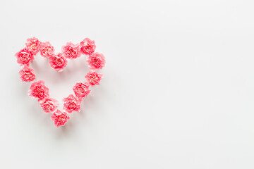Heart made of pink flowers for greeting card. Valentines Day, wedding or birthday
