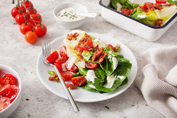 romaine lettuce topped with bacon tomato parmesan, sauce. healthy keto paleo diet lunch