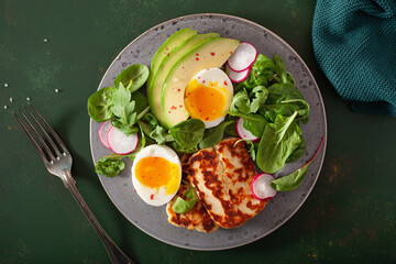 healthy keto paleo diet breakfast: boiled egg, avocado, halloumi cheese, salad leaves