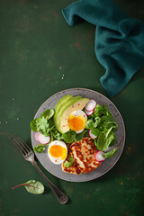healthy keto paleo diet breakfast: boiled egg, avocado, halloumi cheese, salad leaves