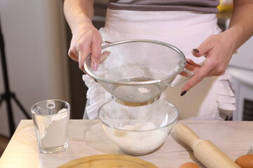 Girl sifting flour