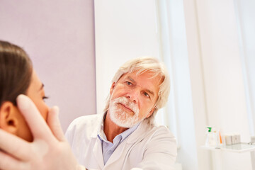 Dermatologist examines a patient's skin
