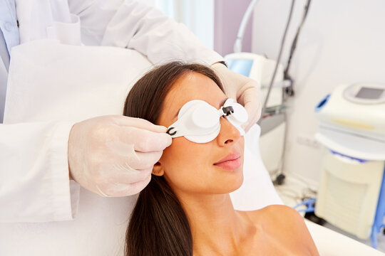 Woman patient with safety glasses waiting for laser therapy