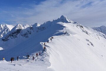Fototapeta na wymiar Kasprowy Wierch mountain, winter in the Tatras, tourists and skiers