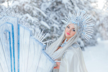 Young girl snow queen in the forest. The crown of the snow queen, the throne of ice. The queen's...
