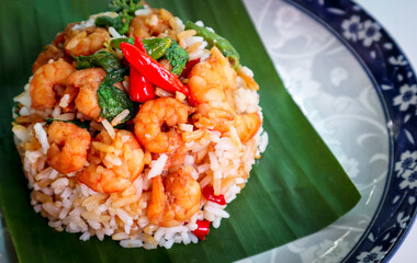 Stir fried shrimp and basil with steamed rice call khao pad kra pao in Thai.