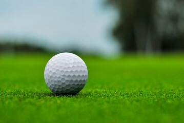 Golf ball on a green golf course with a blurred background