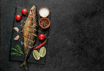 grilled mackerel with lime and spices on stone background with copy space for your text
