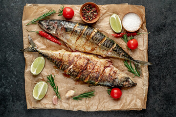 grilled mackerel with lime and spices on stone background