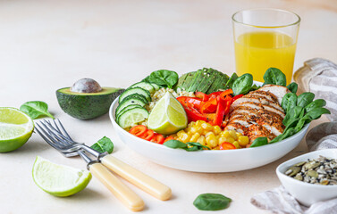 Bowl with bulgur, grilled chicken, bell pepper, cucumber, corn, avocado and spinach. Buddha bowl. Healthy food concept.