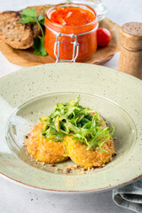 Several chickpea cutlets on a white round plate filmed in decor