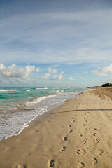 Beach with blue green sea. Footprints in the sand on the beach. Vacation by the sea in Cuba 