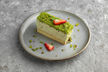 Pistachio cheesecake with strawberries. Delicious airy dessert.