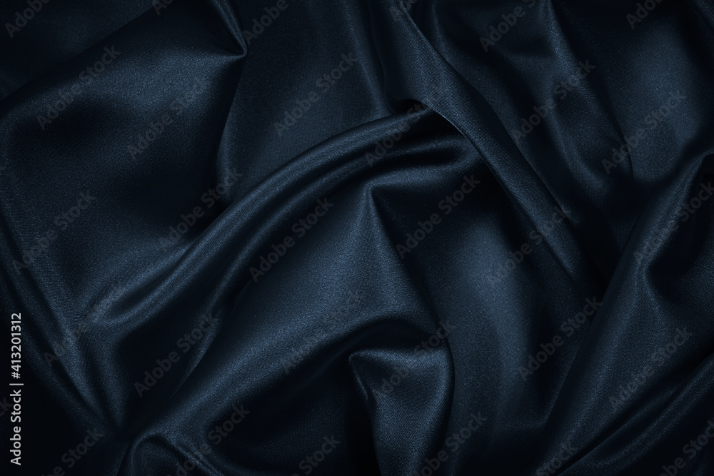 Wall mural black blue abstract background. dark blue silk satin texture. beautiful wavy soft folds on the surfa