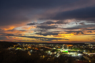 Night city lights in winter at sunset
