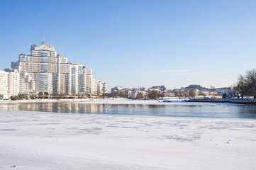 Cityscape on the city near the river on a winter sunny day