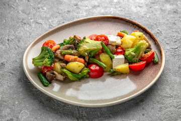 Nutritious, vitamin salad made from steamed vegetables: potatoes, broccoli, carrots. Diet, vegetarian food.