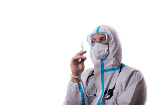 Man In Protective Suit, Medical Mask, Goggles With Arms Crossed. Isolated In Studio