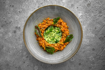 Vegetarian nutritious fitness dish of zucchini stew, eggplant, tomatoes and avocado, cucumber, pine nuts and sauce salad. Gourmet restaurant menu. Flat lay top view