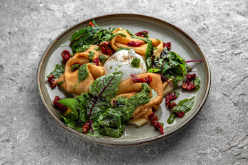 Pancakes with burrata cheese, sun-dried tomatoes, beet leaves and pesto sauce. Delicious, hearty, nutritious breakfast. Balanced nutrition for beauty and health.