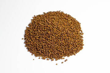 Buckwheat tea on a white background. Isolate. Buckwheat tea close-up macro photography. Scattered buckwheat tea pellets on white background top view.