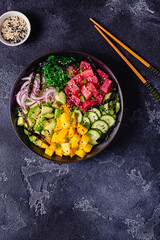 Hawaiian tuna poke bowl with seaweed, avocado, mango, cucumber.
