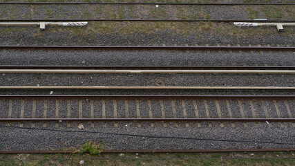 Rusty train tracks with grass