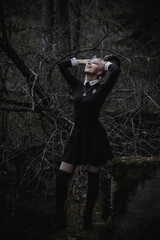 Naklejka premium Witch in the form of a student in the forest