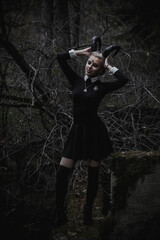 Naklejka premium Witch in the form of a student in the forest