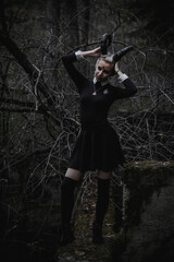 Naklejka premium Witch in the form of a student in the forest