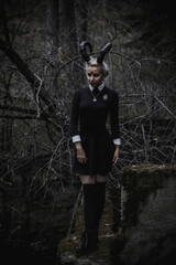 Naklejka premium Witch in the form of a student in the forest