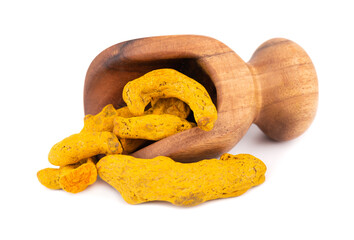 Dry turmeric root in wooden scoop, isolated on white background. Curcuma longa linn.