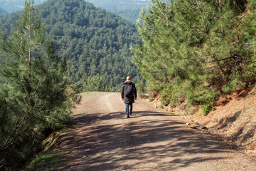 Healthy man walking alone on mountain roads outdoors. To get out of quarantine and be free after the pandemic.