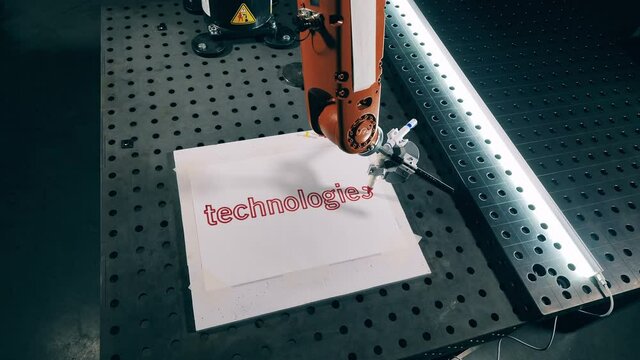 Robotic arm is writing on paper with a sharpie