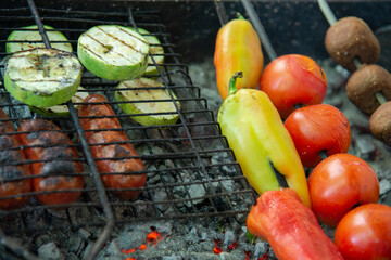 Sausages and vegetables on the barbecue grill. The concept of a summer picnic
