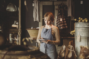 Antique store owner using digital tablet