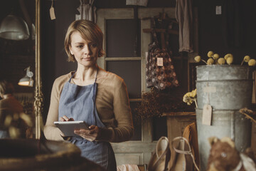 Antique store owner using digital tablet